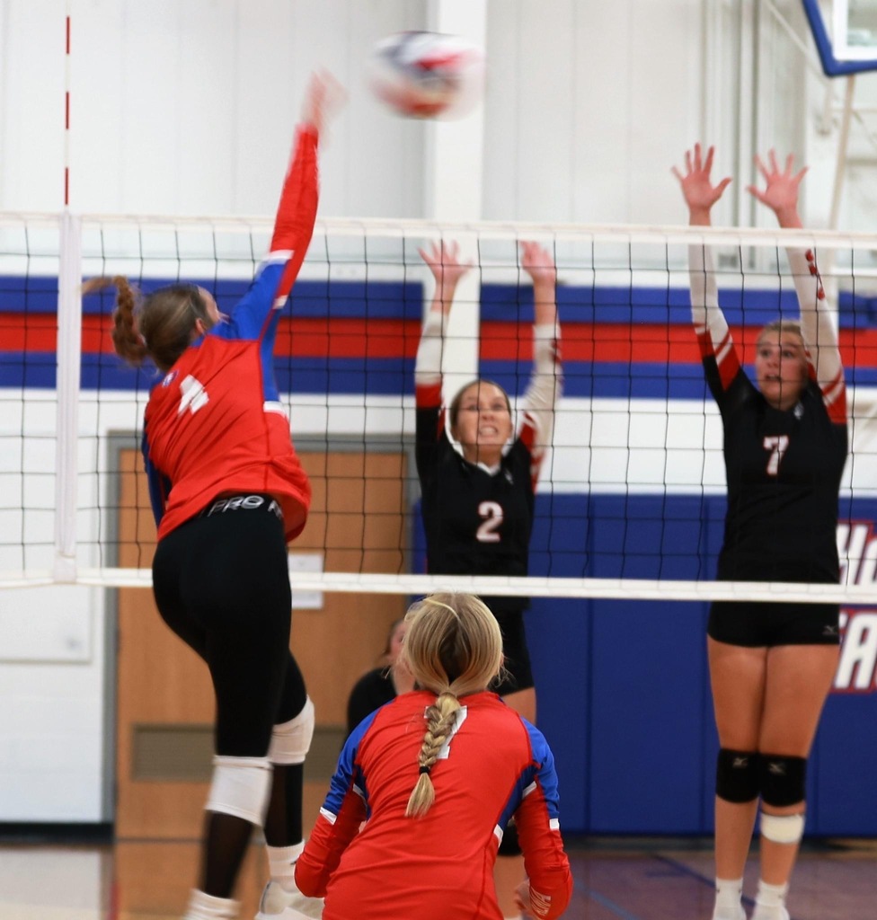 The Pirates attempt a block as Macy Stewart attacks from the outside 